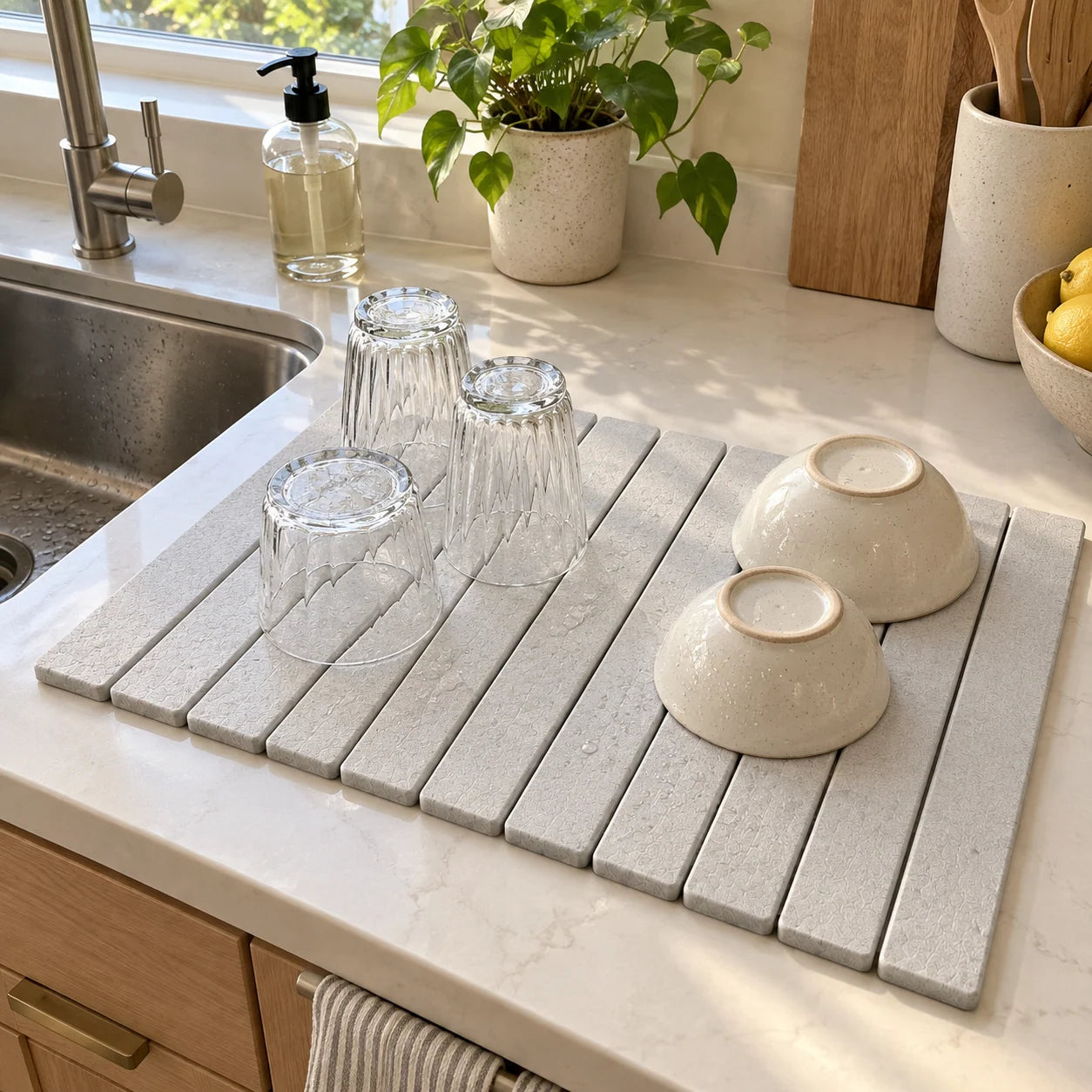 Chalk White stone drying mat beside a kitchen sink